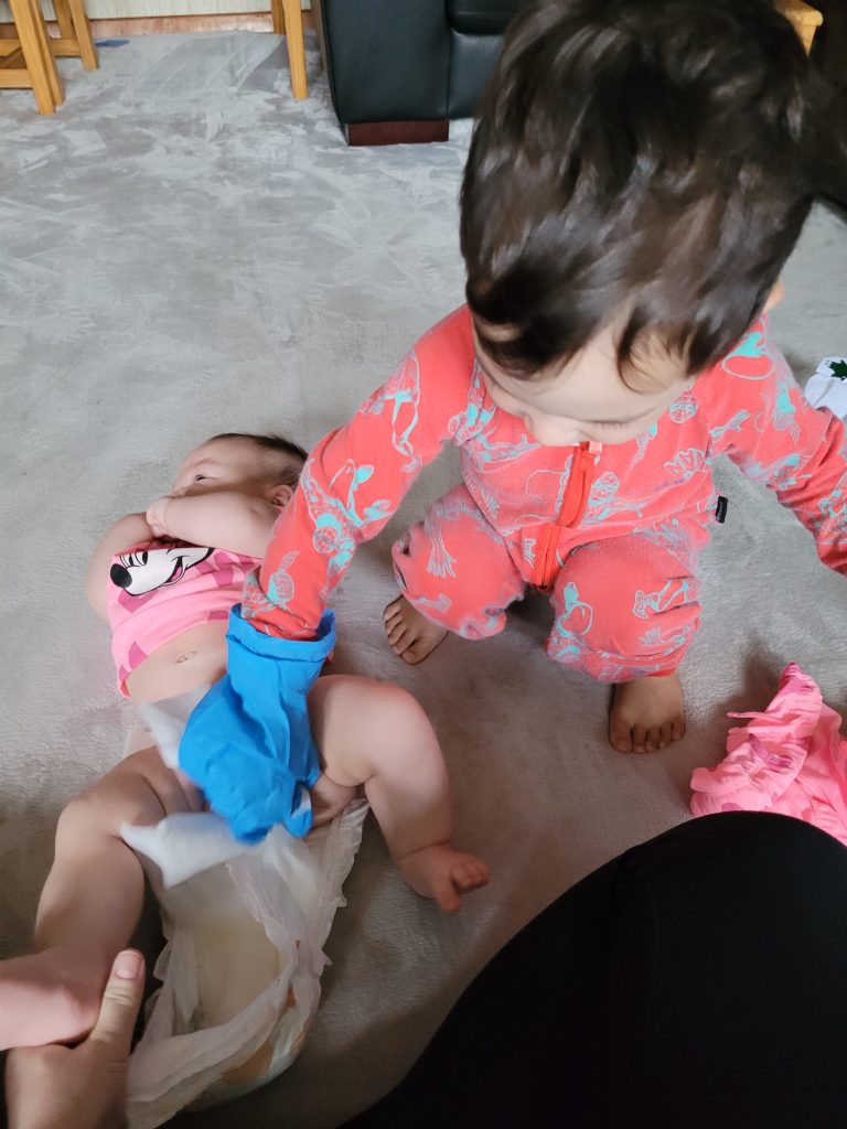 Rahim Changing Aisha's Nappy