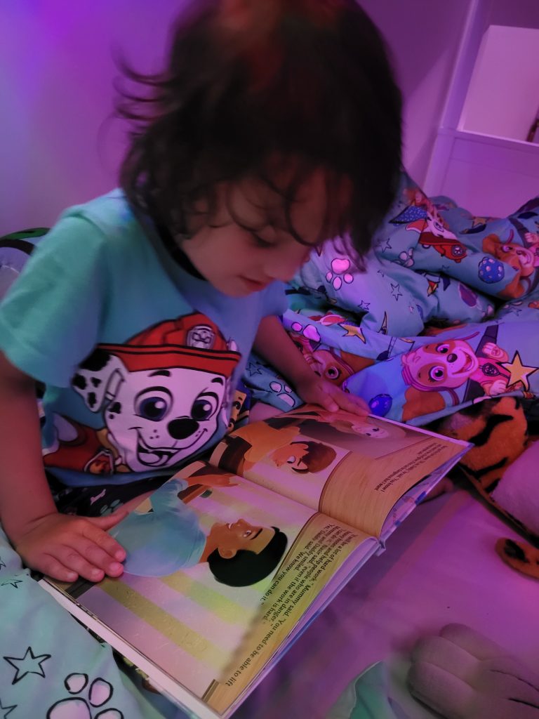 Nasir Reading A Book About Himself as a Firefighter